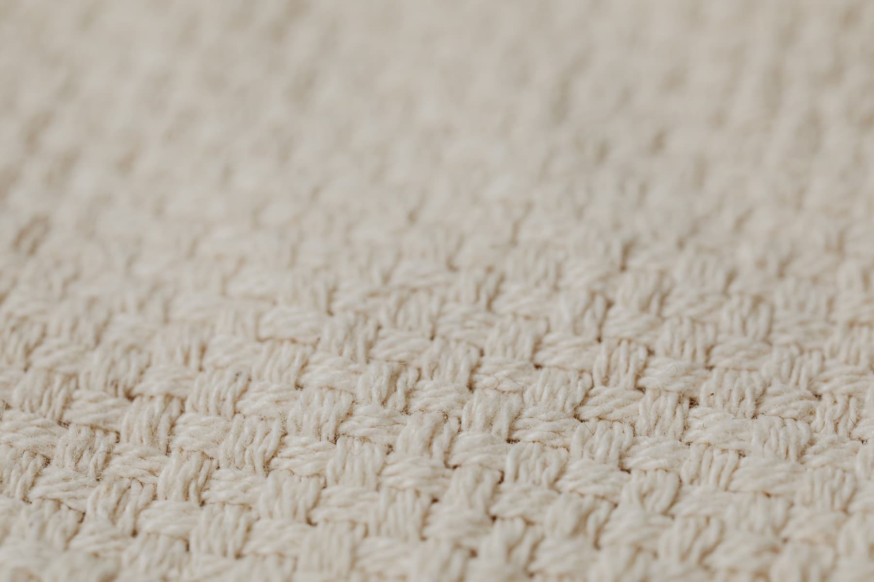 Close-up of natural linen fabric showing its open weave